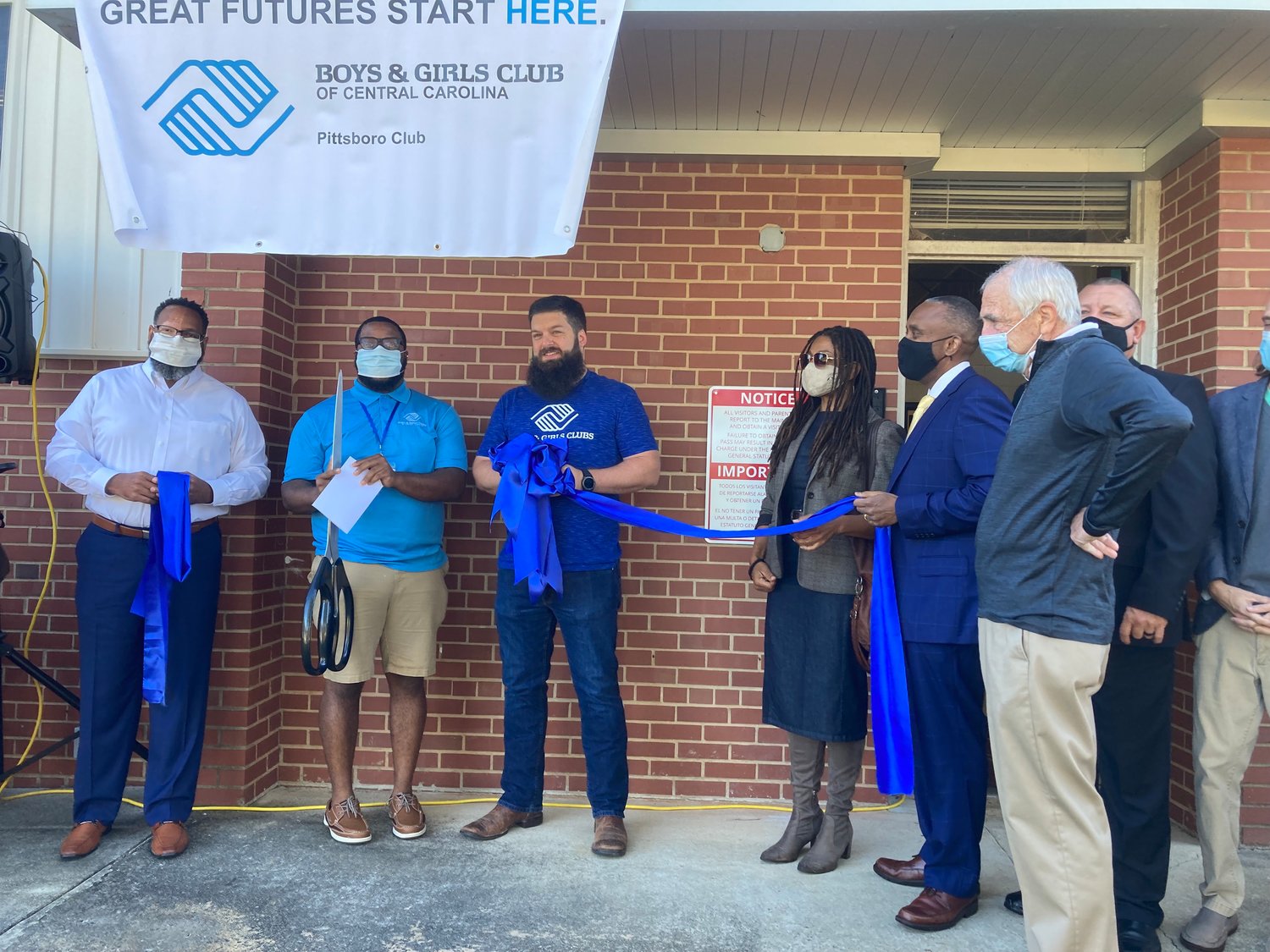 Pittsboro Commissioner Kyle Shipp (center, with beard) and local officials gathered Monday for the official ribbon-cutting of the new Boys & Girls Club of Pittsboro
